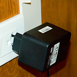 Power adapter hanging from the wall Power adapter hanging from the wall